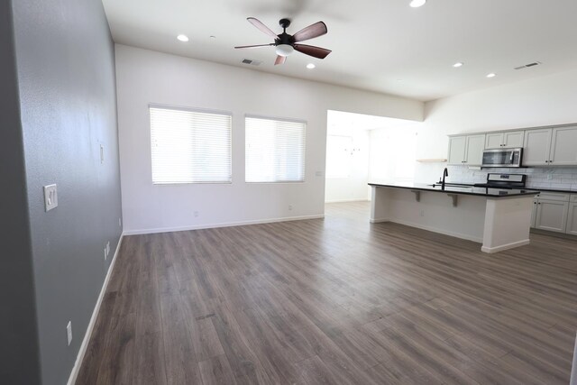 879 Hermosa Ave, Clovis, CA 93619 - unfurnished living room with recessed lighting, dark wood-style floors, and ceiling fan
