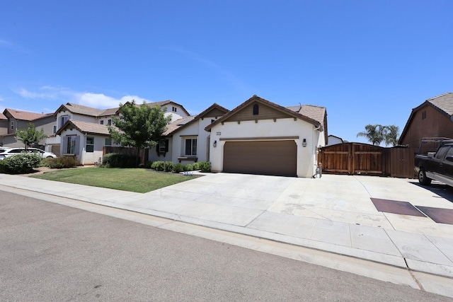 879 Hermosa Ave, Clovis, CA 93619 - view of front of home featuring an attached garage, a tiled roof, stucco siding, a gate, and concrete driveway