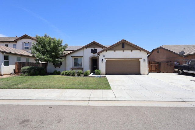 879 Hermosa Ave, Clovis, CA 93619 - ranch-style home with solar panels, a garage, stucco siding, driveway, and a tile roof