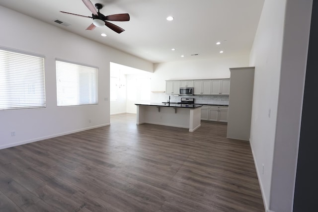879 Hermosa Ave, Clovis, CA 93619 - kitchen with stainless steel appliances, open floor plan, ceiling fan, recessed lighting, and dark wood-style flooring
