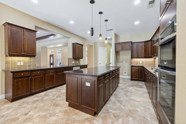 5857 W Modoc, Visalia, CA 93291 - kitchen with tasteful backsplash, recessed lighting, an island with sink, pendant lighting, and dark stone countertops