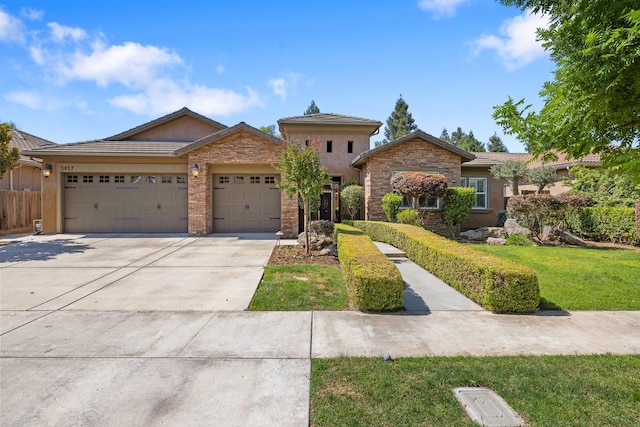5857 W Modoc, Visalia, CA 93291 - ranch-style home with an attached garage, driveway, a front lawn, stone siding, and stucco siding