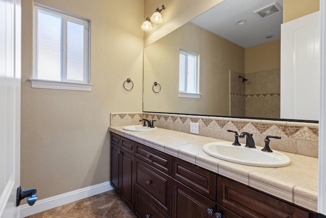 5857 W Modoc, Visalia, CA 93291 - bathroom featuring double vanity, a tile shower, and tasteful backsplash