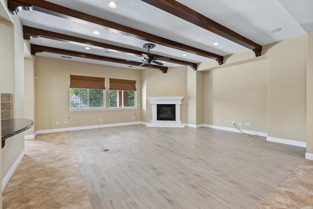 5857 W Modoc, Visalia, CA 93291 - unfurnished living room featuring a ceiling fan, a glass covered fireplace, beam ceiling, recessed lighting, and light wood finished floors