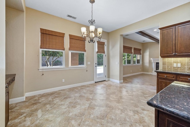 5857 W Modoc, Visalia, CA 93291 - kitchen with a chandelier, backsplash, dark stone countertops, and pendant lighting