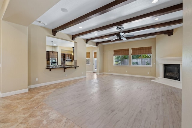 5857 W Modoc, Visalia, CA 93291 - unfurnished living room featuring ceiling fan, beam ceiling, a glass covered fireplace, recessed lighting, and light wood-style floors