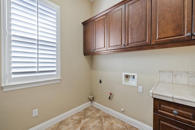 5857 W Modoc, Visalia, CA 93291 - laundry area featuring hookup for a gas dryer, hookup for an electric dryer, light tile patterned floors, cabinet space, and washer hookup