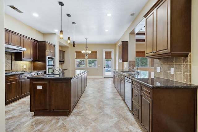 5857 W Modoc, Visalia, CA 93291 - kitchen featuring stainless steel appliances, an island with sink, a chandelier, dark stone counters, and tasteful backsplash