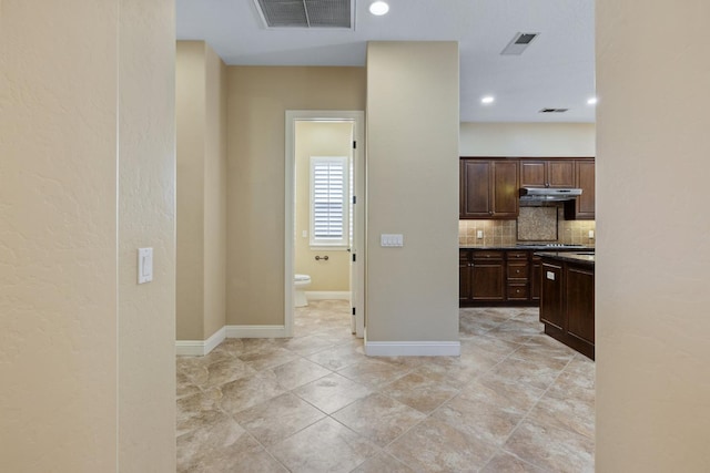 5857 W Modoc, Visalia, CA 93291 - kitchen featuring under cabinet range hood, tasteful backsplash, dark brown cabinetry, recessed lighting, and light tile patterned floors