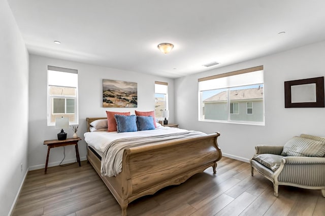 4086 Dennis Ave, Clovis, CA 93619 - bedroom featuring wood finished floors and multiple windows