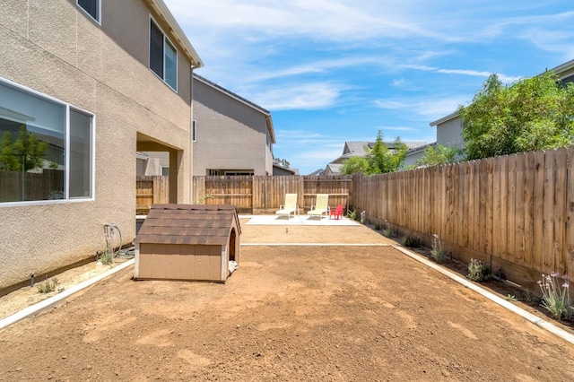 4086 Dennis Ave, Clovis, CA 93619 - fenced backyard featuring a fire pit, a storage unit, and a patio area