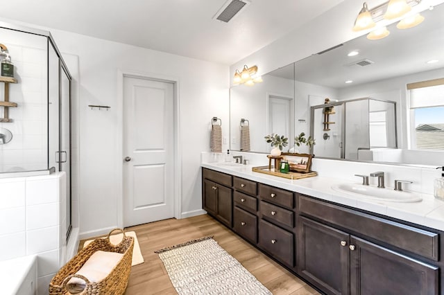 4086 Dennis Ave, Clovis, CA 93619 - bathroom with double vanity, a shower stall, and wood finished floors