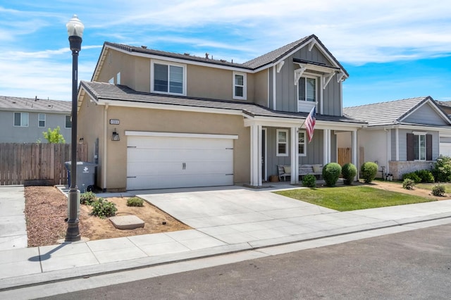 4086 Dennis Ave, Clovis, CA 93619 - traditional-style home featuring board and batten siding, covered porch, driveway, and a garage