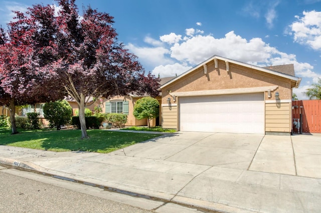 564 S Duke Ave, Fresno, CA 93727 - view of front of house with an attached garage, concrete driveway, and stucco siding