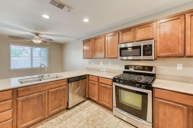564 S Duke Ave, Fresno, CA 93727 - kitchen with stainless steel appliances, brown cabinets, a ceiling fan, light countertops, and recessed lighting