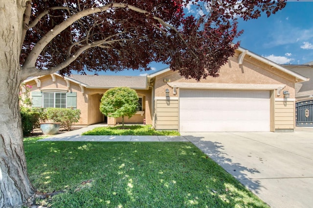 564 S Duke Ave, Fresno, CA 93727 - ranch-style house featuring an attached garage, concrete driveway, a front lawn, and stucco siding