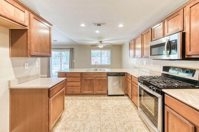 564 S Duke Ave, Fresno, CA 93727 - kitchen featuring appliances with stainless steel finishes, a peninsula, recessed lighting, ceiling fan, and brown cabinetry