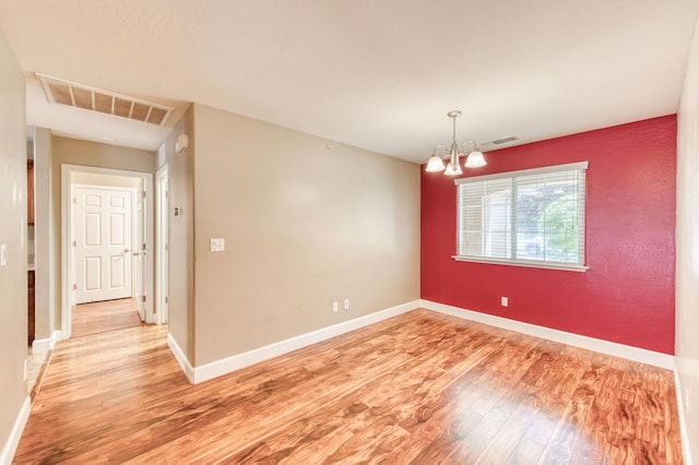 564 S Duke Ave, Fresno, CA 93727 - empty room featuring light wood finished floors and a chandelier