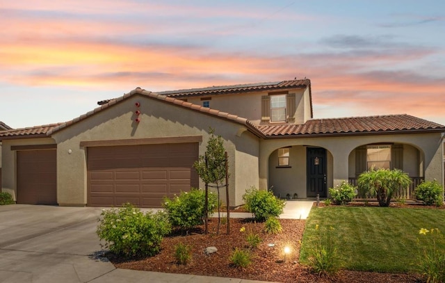 7330 E Princeton Ave, Fresno, CA 93737 - mediterranean / spanish-style home with an attached garage, stucco siding, a tiled roof, and concrete driveway