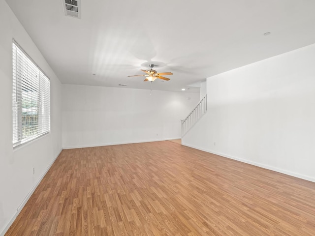 3807 N Pearwood Ave, Fresno, CA 93727 - unfurnished living room featuring light wood finished floors, a ceiling fan, and stairs