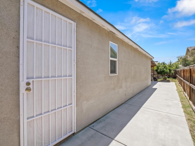 3807 N Pearwood Ave, Fresno, CA 93727 - view of side of property with a fenced backyard, stucco siding, and a patio area