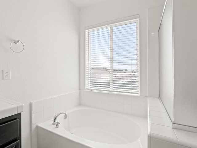 3807 N Pearwood Ave, Fresno, CA 93727 - bathroom featuring a garden tub and vanity