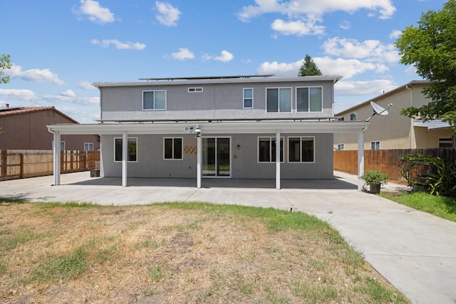 2720 San Jose Ave, Clovis, CA 93611 - rear view of property featuring stucco siding, roof mounted solar panels, a patio area, and a fenced backyard