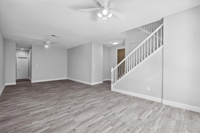 2720 San Jose Ave, Clovis, CA 93611 - unfurnished living room featuring a ceiling fan, stairway, and wood finished floors