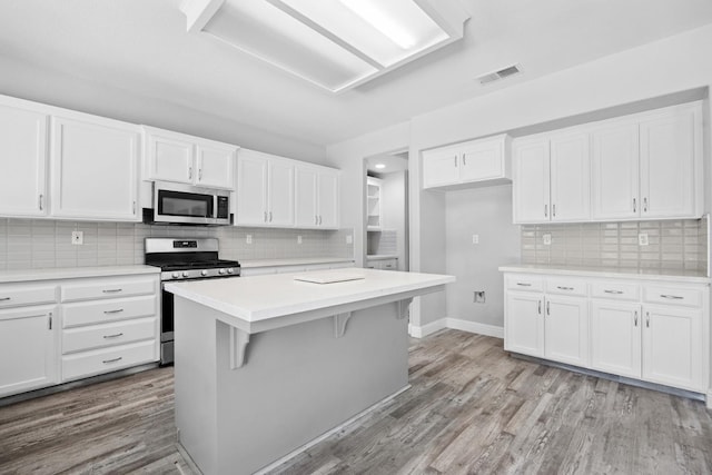 2720 San Jose Ave, Clovis, CA 93611 - kitchen featuring appliances with stainless steel finishes, backsplash, light countertops, and white cabinets