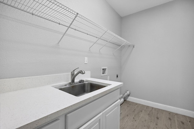 2720 San Jose Ave, Clovis, CA 93611 - washroom featuring electric dryer hookup, hookup for a washing machine, light wood-style floors, and cabinet space
