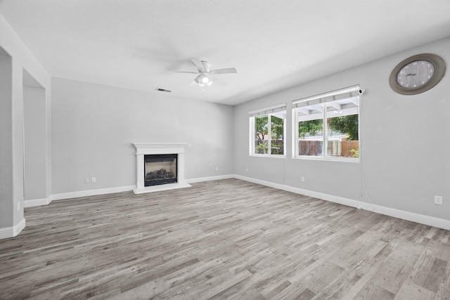2720 San Jose Ave, Clovis, CA 93611 - unfurnished living room featuring a ceiling fan, wood finished floors, and a glass covered fireplace