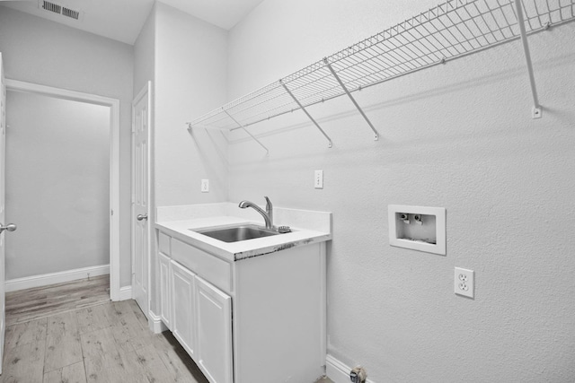 2720 San Jose Ave, Clovis, CA 93611 - laundry room featuring hookup for a washing machine, light wood-type flooring, and cabinet space
