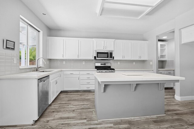 2720 San Jose Ave, Clovis, CA 93611 - kitchen with appliances with stainless steel finishes, backsplash, white cabinetry, a center island, and light countertops