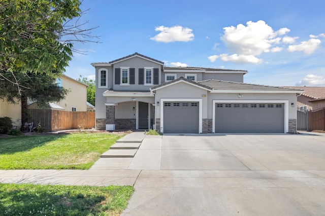 2720 San Jose Ave, Clovis, CA 93611 - view of front of property with concrete driveway, a garage, stone siding, and stucco siding