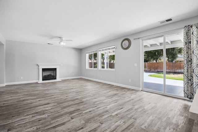 2720 San Jose Ave, Clovis, CA 93611 - unfurnished living room with a ceiling fan, wood finished floors, and a glass covered fireplace