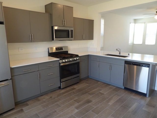 3725 Graystoke Way, Clovis, CA 93619 - kitchen with stainless steel appliances, gray cabinets, a peninsula, and light countertops