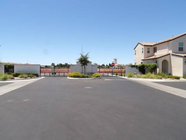 3725 Graystoke Way, Clovis, CA 93619 - view of asphalt street featuring a gate, a gated entry, and curbs