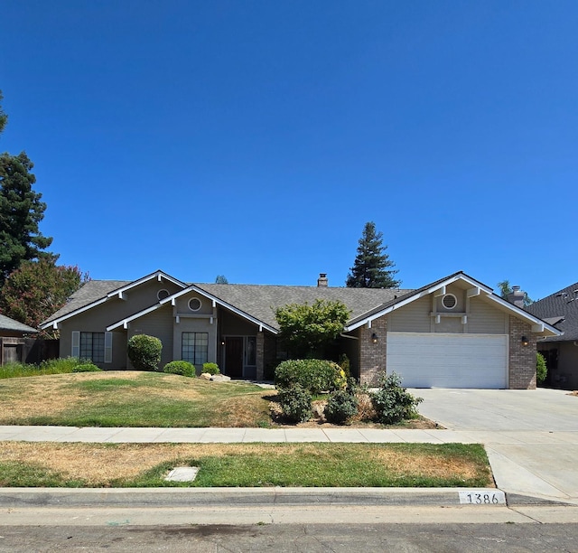 1386 E El Paso Ave, Fresno, CA 93720 - ranch-style house featuring a garage, driveway, a front yard, and brick siding