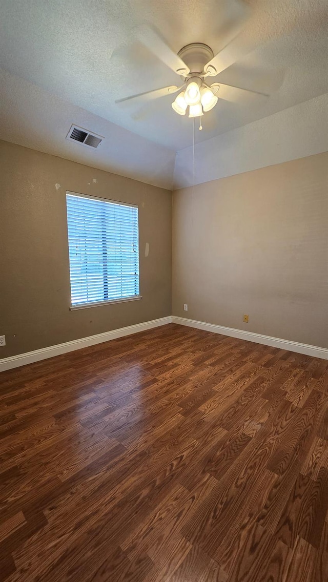 1386 E El Paso Ave, Fresno, CA 93720 - spare room with dark wood finished floors, ceiling fan, and a textured ceiling
