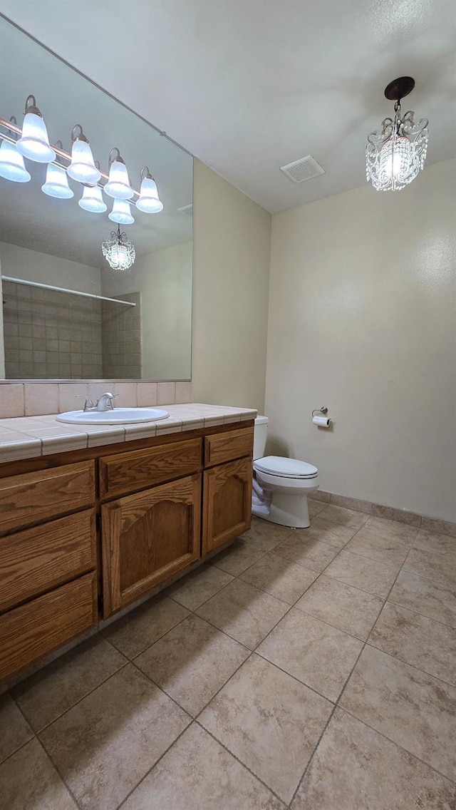 1386 E El Paso Ave, Fresno, CA 93720 - full bath featuring tile patterned flooring, vanity, and a chandelier