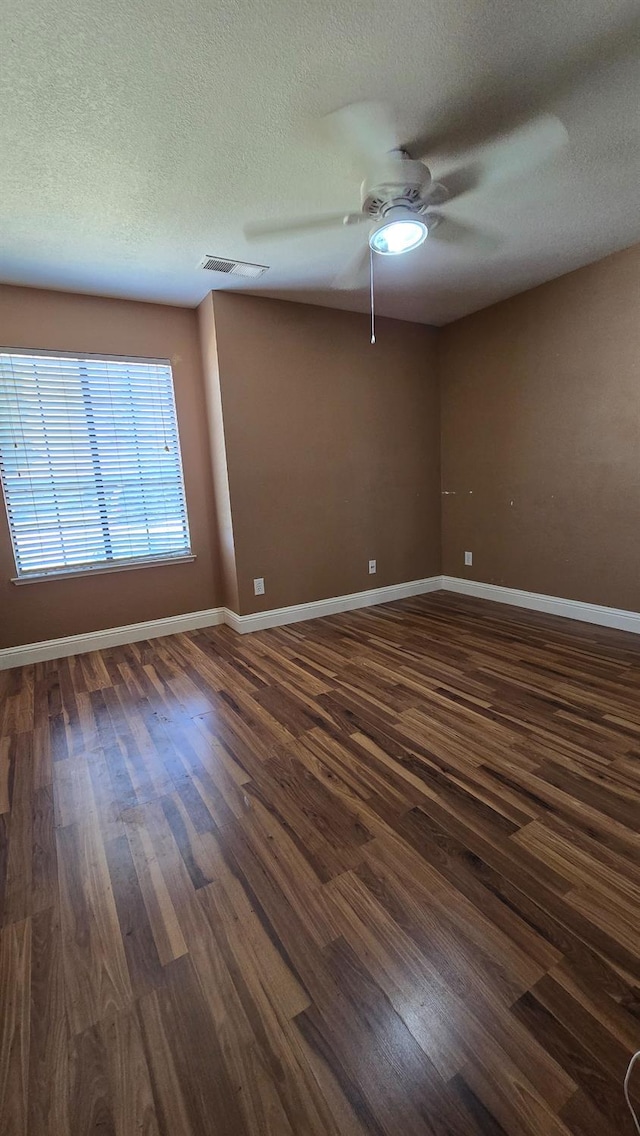 1386 E El Paso Ave, Fresno, CA 93720 - spare room with a ceiling fan, dark wood-style flooring, and a textured ceiling