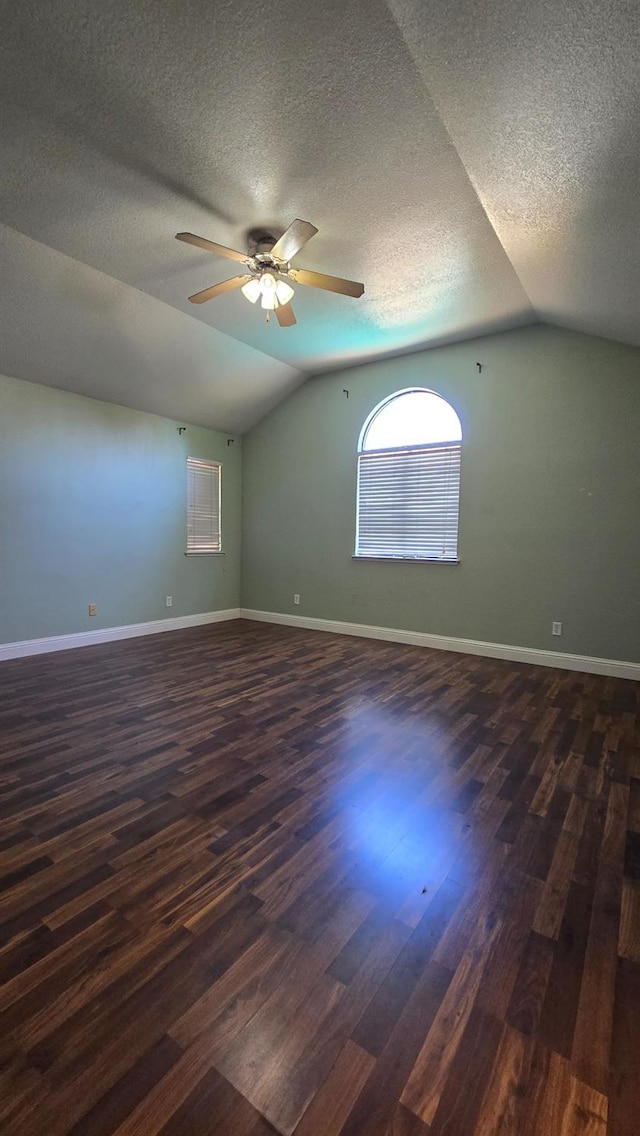 1386 E El Paso Ave, Fresno, CA 93720 - unfurnished room with lofted ceiling, dark wood finished floors, a ceiling fan, and a textured ceiling