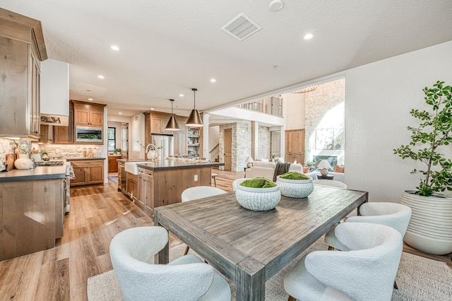42732 Granite Cir, Shaver Lake, CA 93664 - dining room featuring light wood-type flooring, healthy amount of natural light, and recessed lighting
