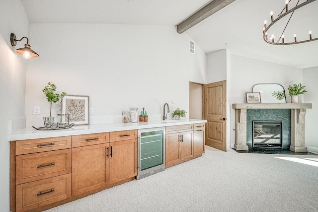42732 Granite Cir, Shaver Lake, CA 93664 - kitchen with wine cooler, light carpet, beam ceiling, a high end fireplace, and light countertops