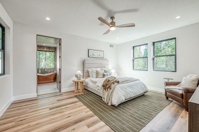 42732 Granite Cir, Shaver Lake, CA 93664 - bedroom with light wood-type flooring, multiple windows, a textured ceiling, connected bathroom, and ceiling fan