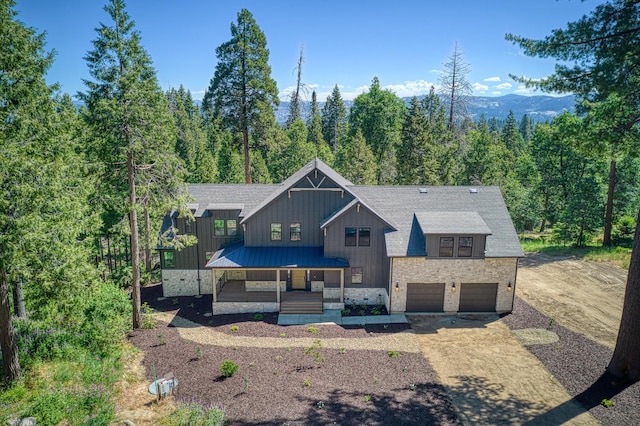 42732 Granite Cir, Shaver Lake, CA 93664 - view of front of property featuring board and batten siding, a porch, concrete driveway, a garage, and roof with shingles