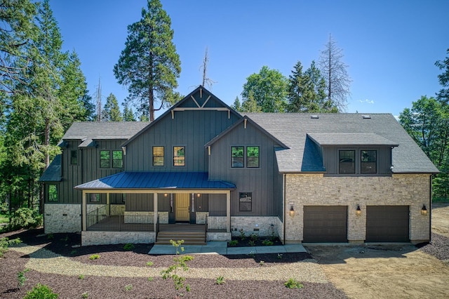 42732 Granite Cir, Shaver Lake, CA 93664 - modern inspired farmhouse featuring a porch, board and batten siding, an attached garage, driveway, and stone siding