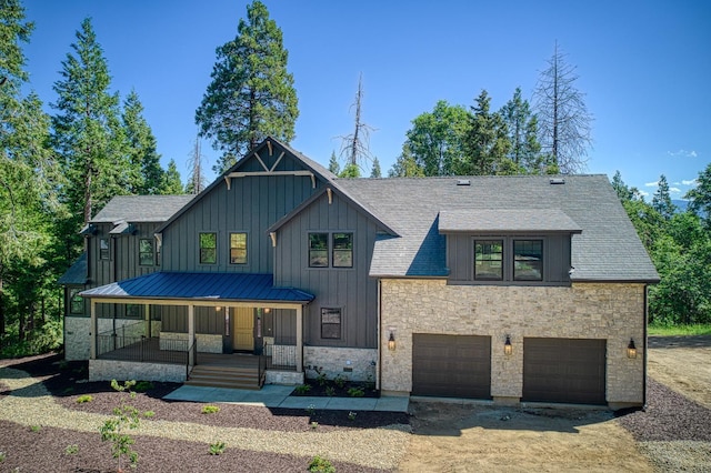 42732 Granite Cir, Shaver Lake, CA 93664 - modern farmhouse style home featuring covered porch, board and batten siding, a garage, stone siding, and dirt driveway