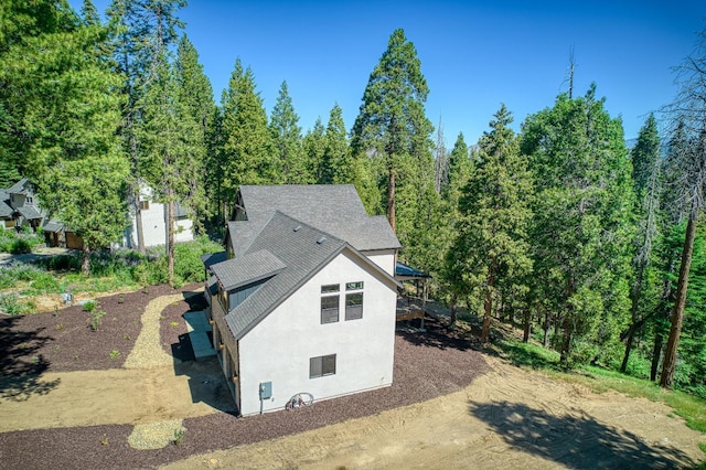 42732 Granite Cir, Shaver Lake, CA 93664 - view of side of property featuring stucco siding and a shingled roof