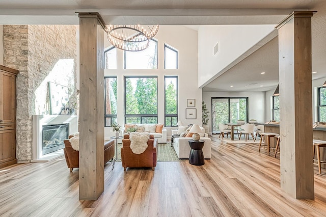 42732 Granite Cir, Shaver Lake, CA 93664 - living room featuring light wood-style flooring, a chandelier, and a high ceiling